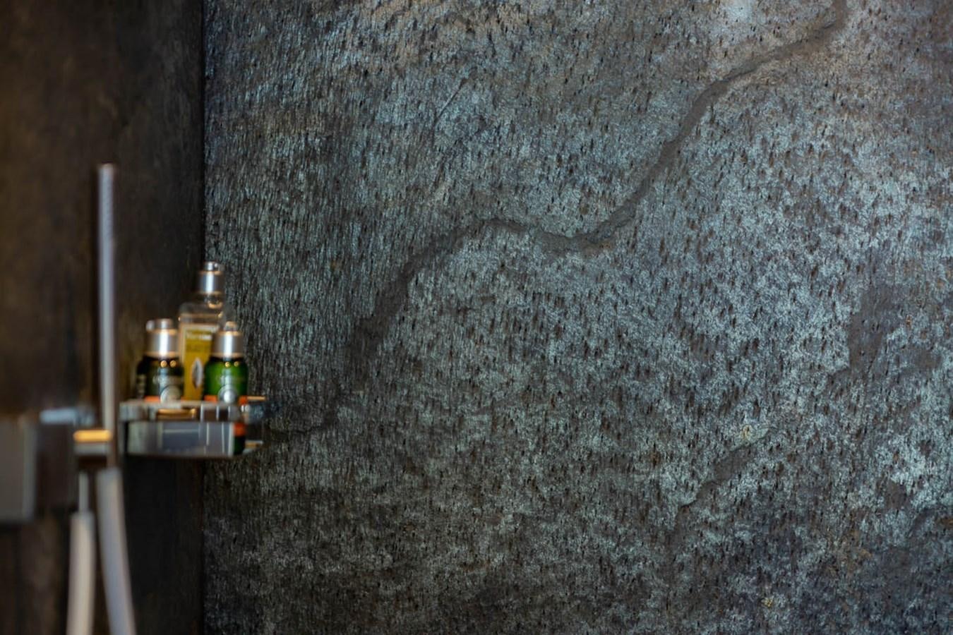 a concrete wall with bottles on it aboard X-TREM II Yacht for Sale