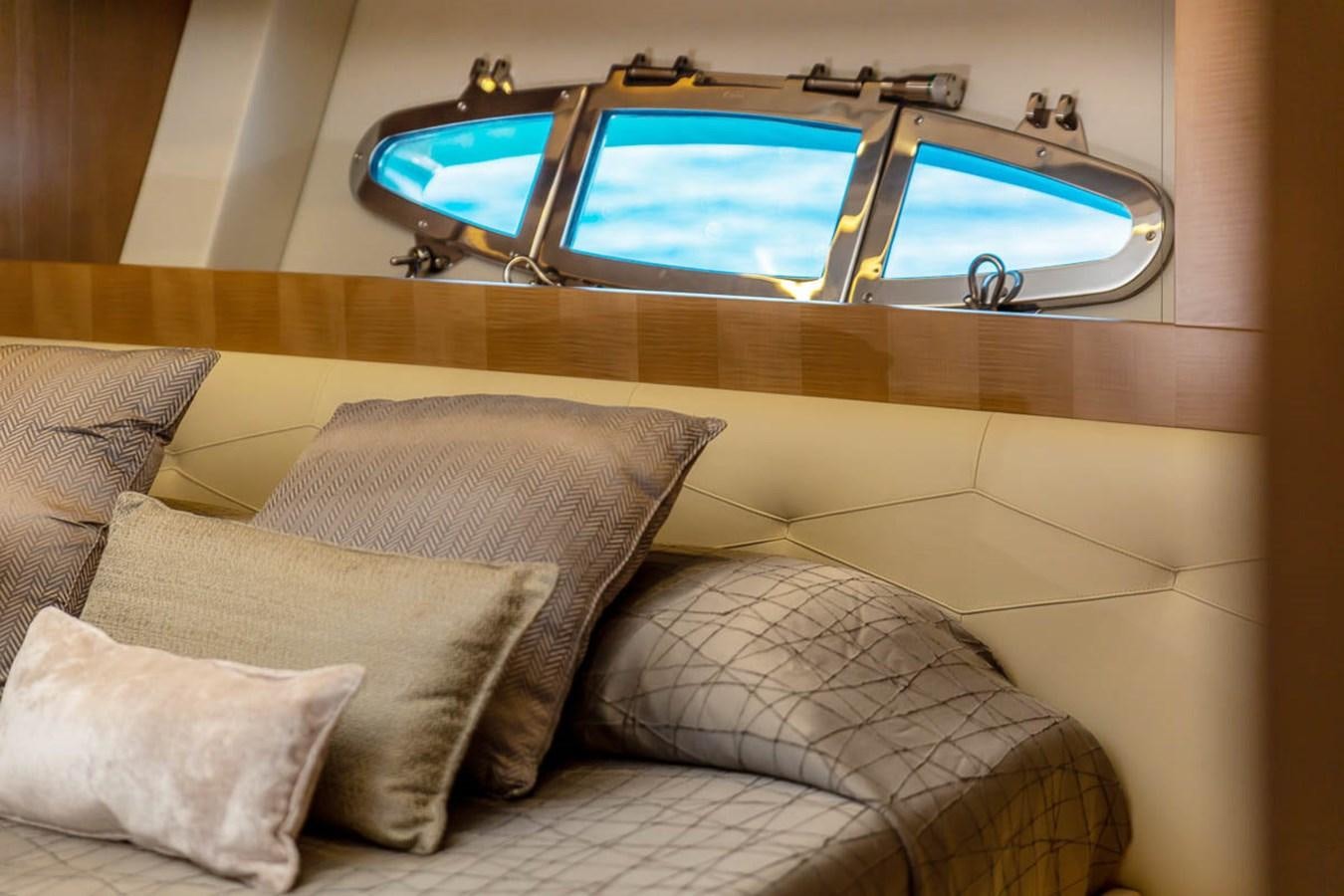 a room with a bed and a window aboard X-TREM II Yacht for Sale