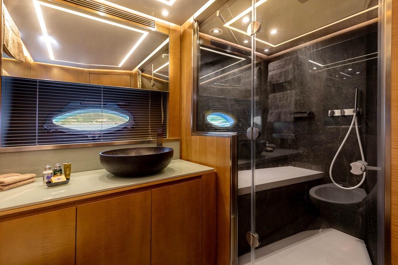 a bathroom with a sink and a large mirror aboard X-TREM II Yacht for Sale
