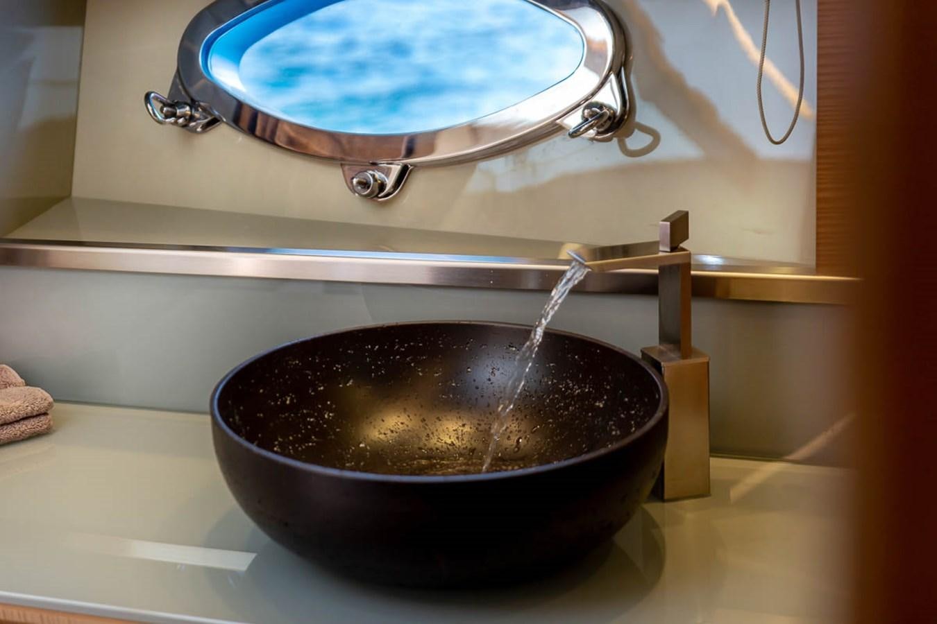 a bowl of water being poured into a sink aboard X-TREM II Yacht for Sale