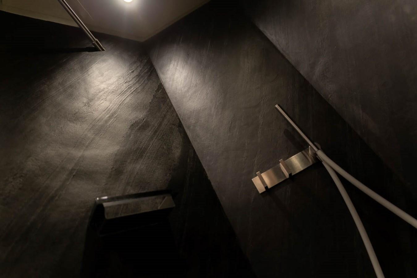 a black and white photo of a staircase with a metal railing aboard X-TREM II Yacht for Sale