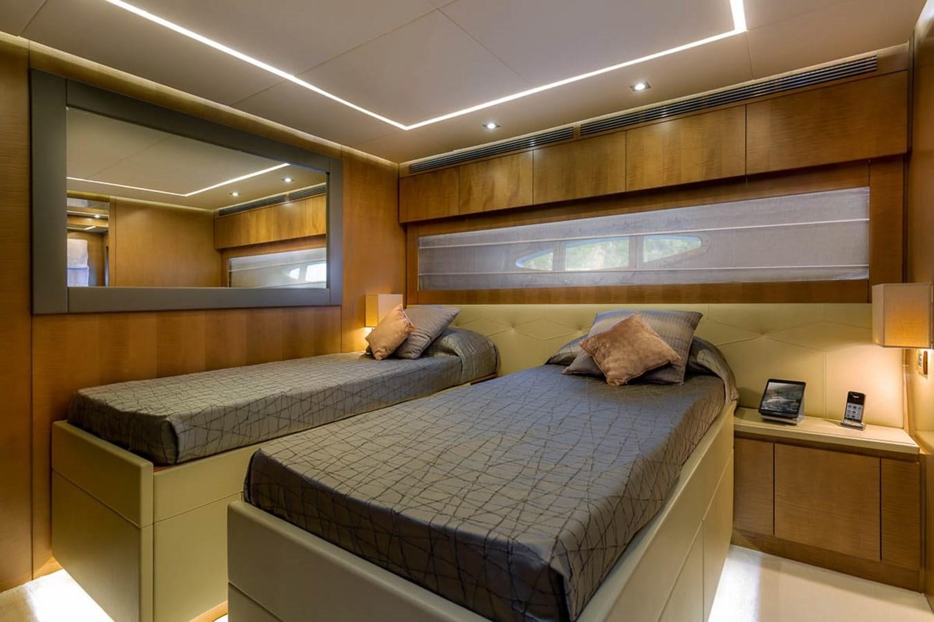 a room with a bed and a mirror aboard X-TREM II Yacht for Sale