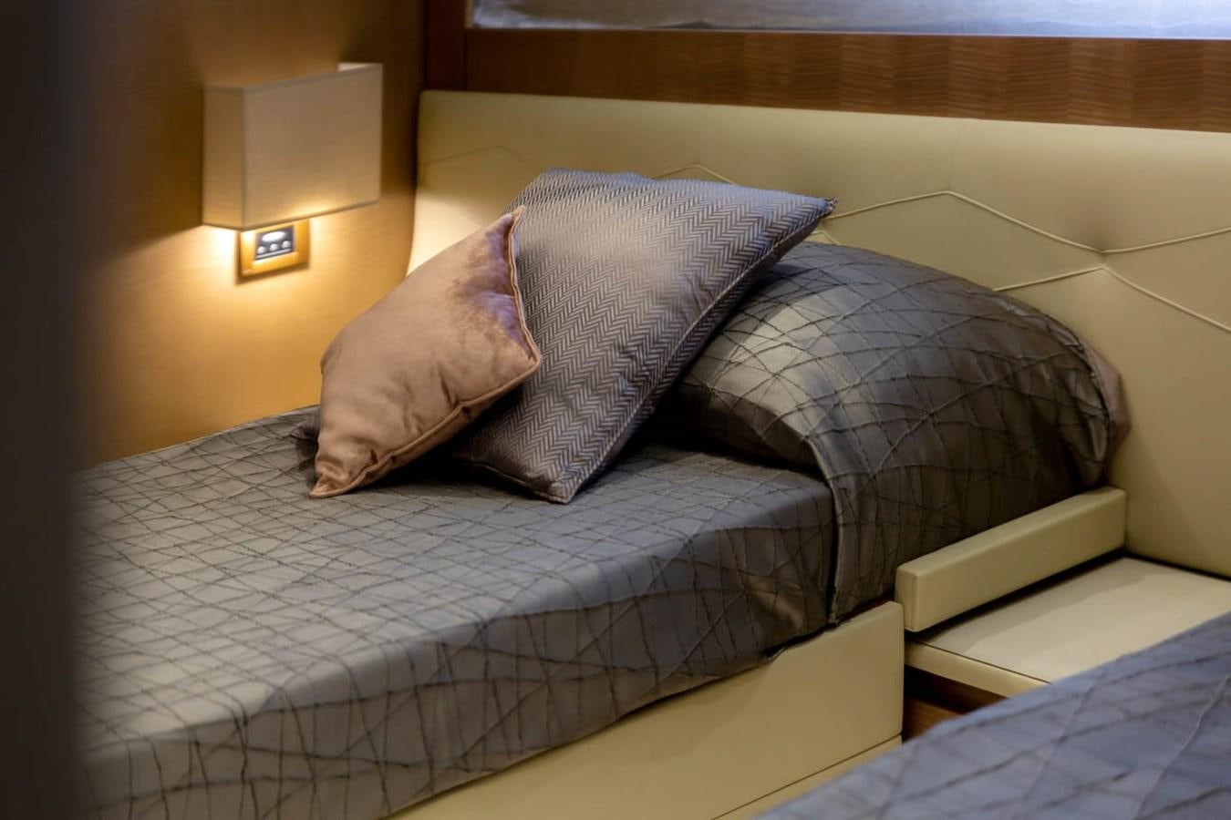 a bed with pillows aboard X-TREM II Yacht for Sale