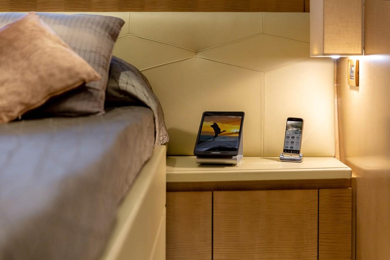 a bed with a phone on it aboard X-TREM II Yacht for Sale