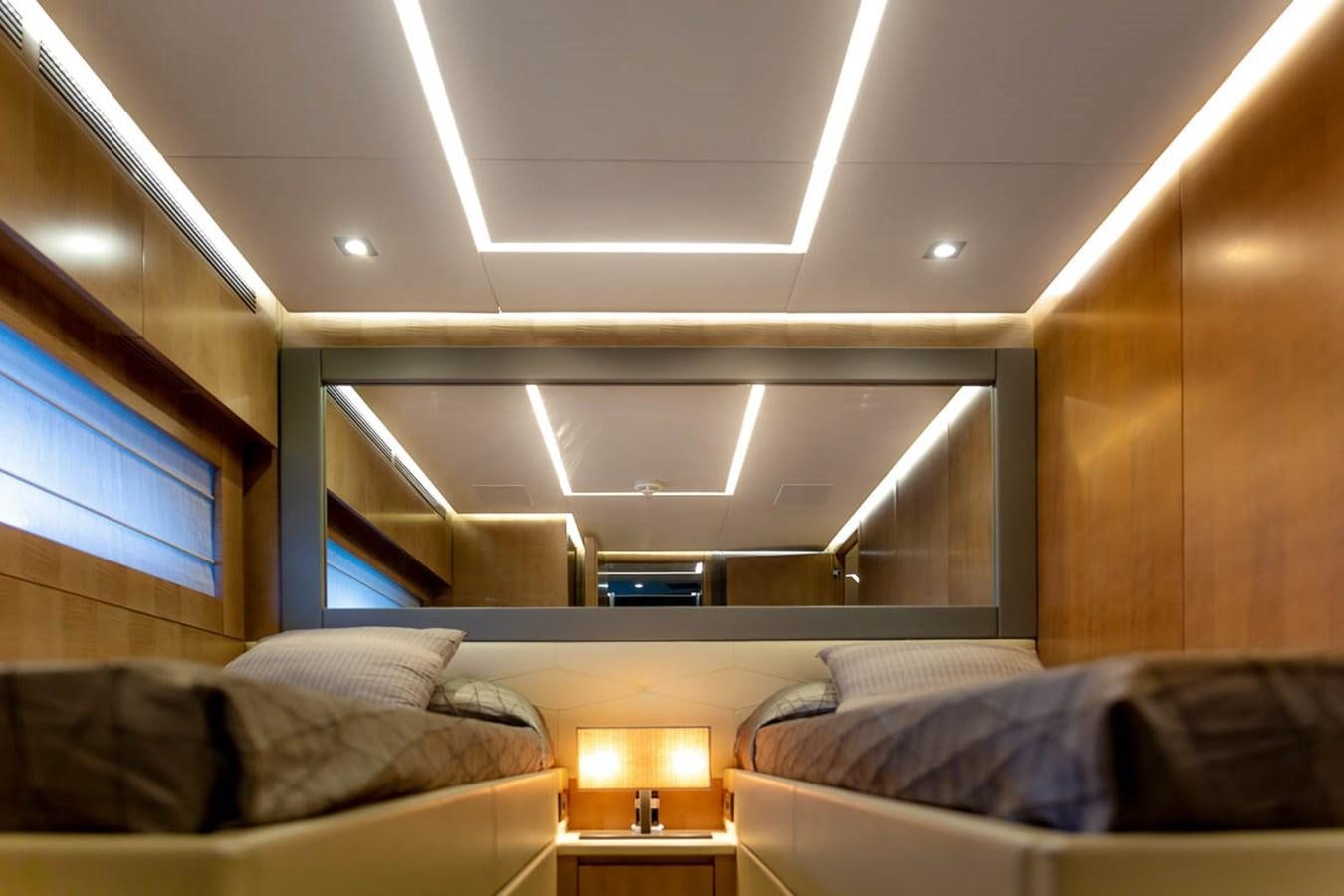 a room with a bed and a window aboard X-TREM II Yacht for Sale