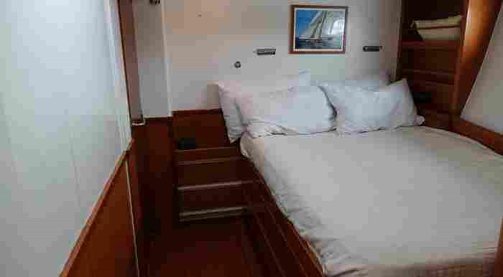 a bed with white sheets aboard FIFTY FIFTY Yacht for Sale