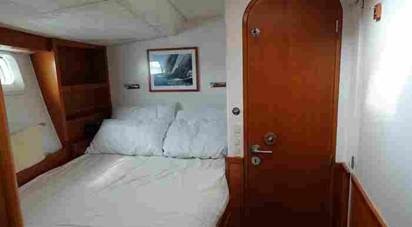 a room with a bed and a door aboard FIFTY FIFTY Yacht for Sale