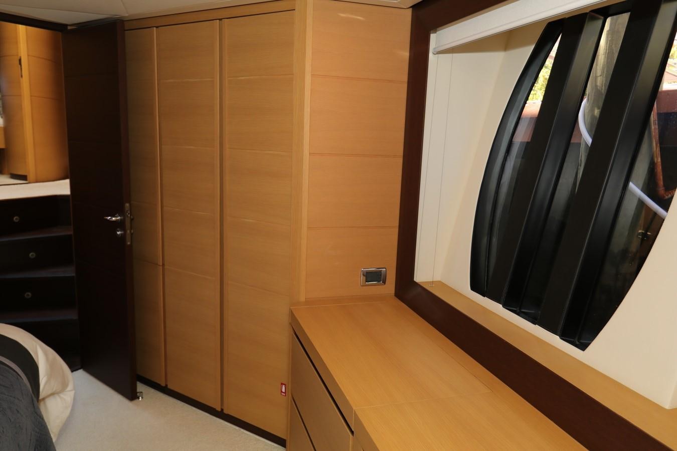 a room with a closet and a window aboard VANTAGE Yacht for Sale