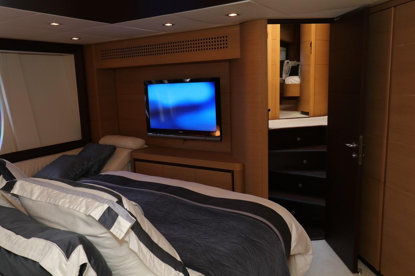 a bedroom with a tv on the wall aboard VANTAGE Yacht for Sale