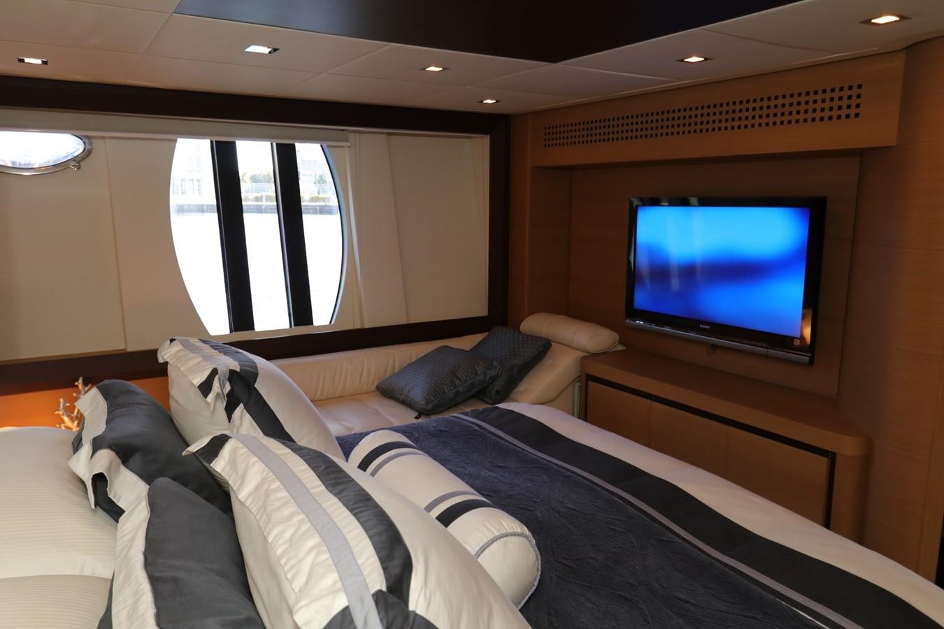 a bedroom with a tv on the wall aboard VANTAGE Yacht for Sale