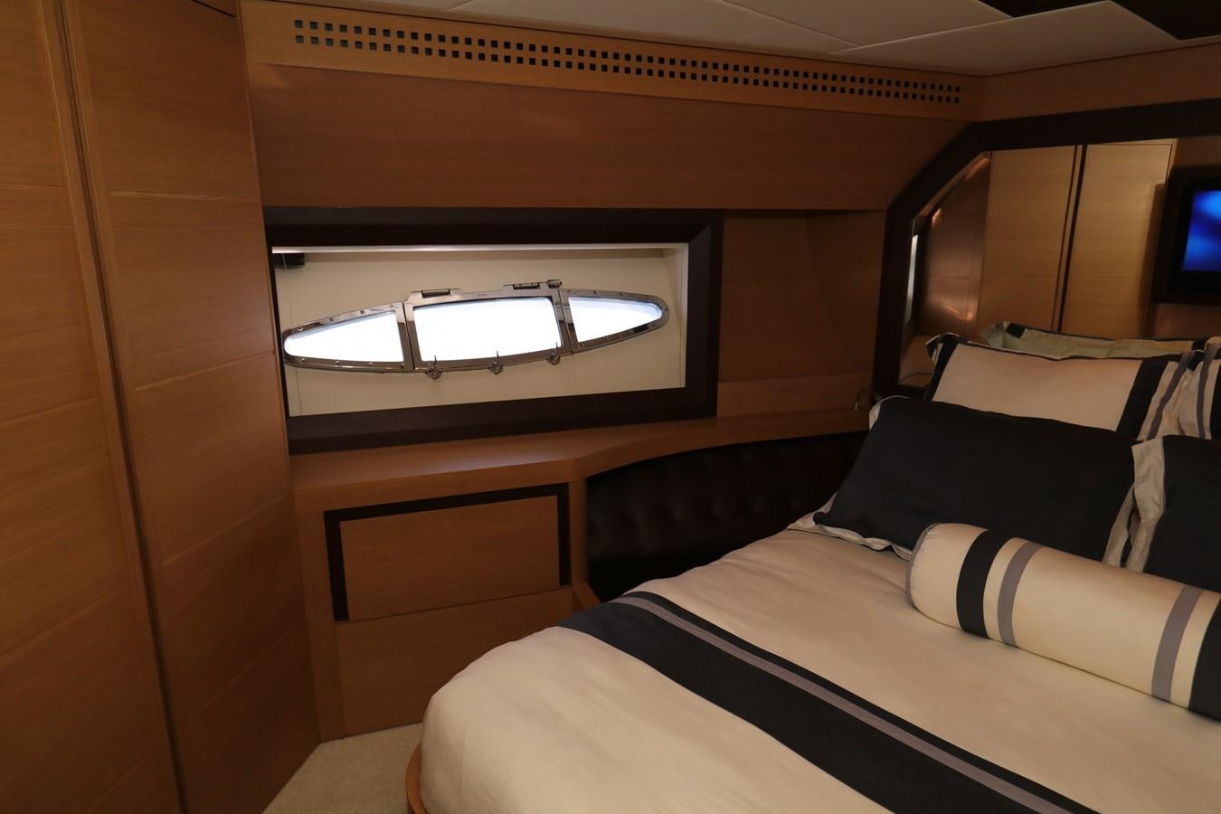 a bed with a television on the wall aboard VANTAGE Yacht for Sale