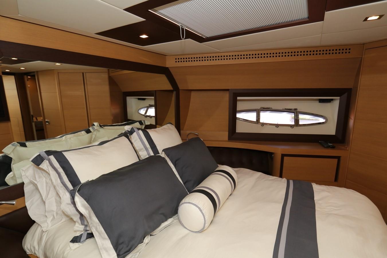 a bed with a television on the wall aboard VANTAGE Yacht for Sale