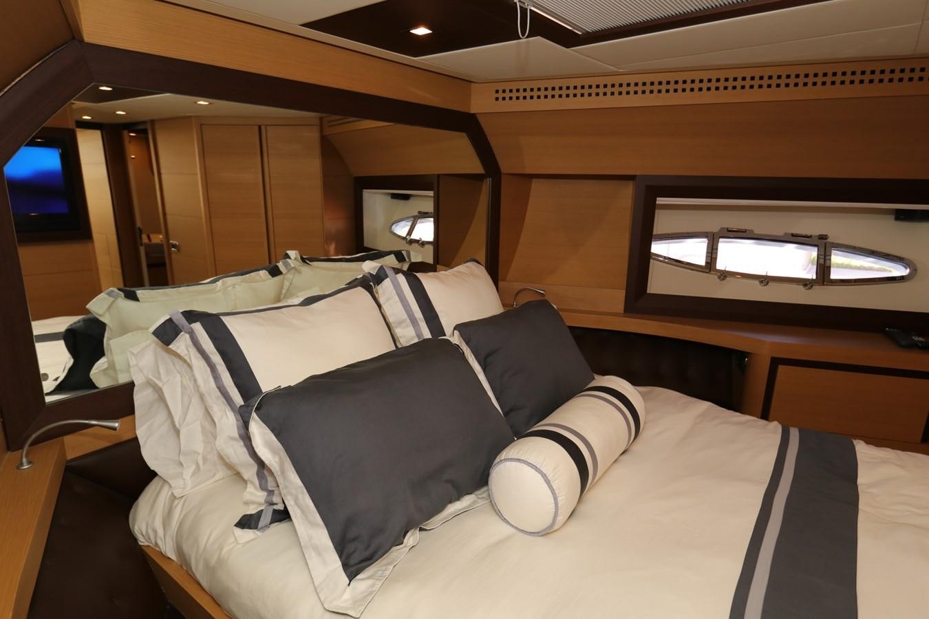 a bed with a white comforter aboard VANTAGE Yacht for Sale