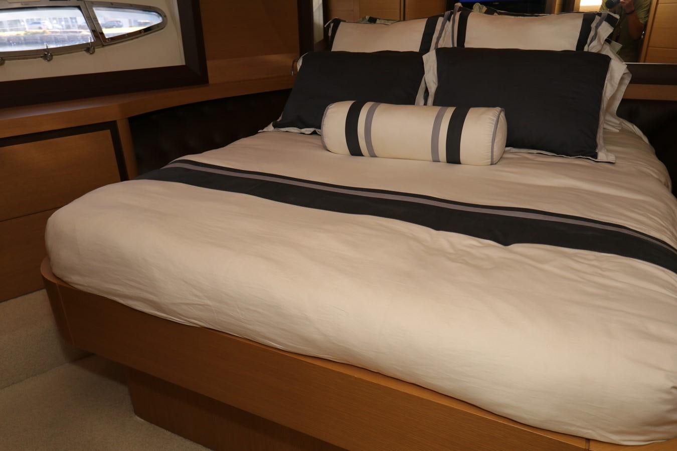 a bed with a blue and white bed spread aboard VANTAGE Yacht for Sale