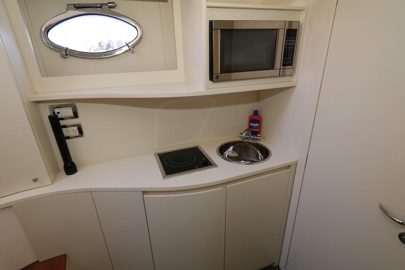 a sink with a microwave above it aboard VANTAGE Yacht for Sale