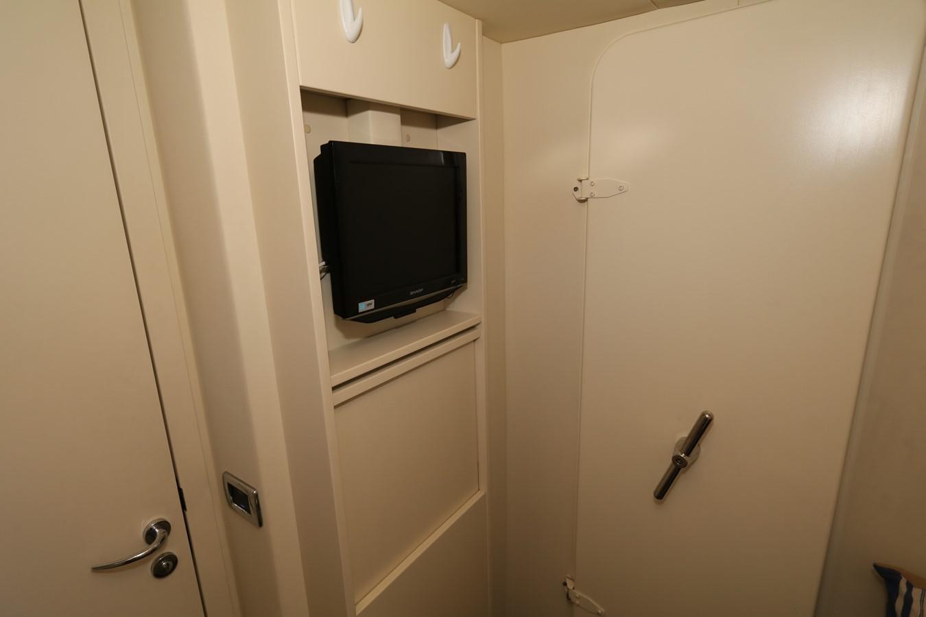 a tv mounted on a wall aboard VANTAGE Yacht for Sale