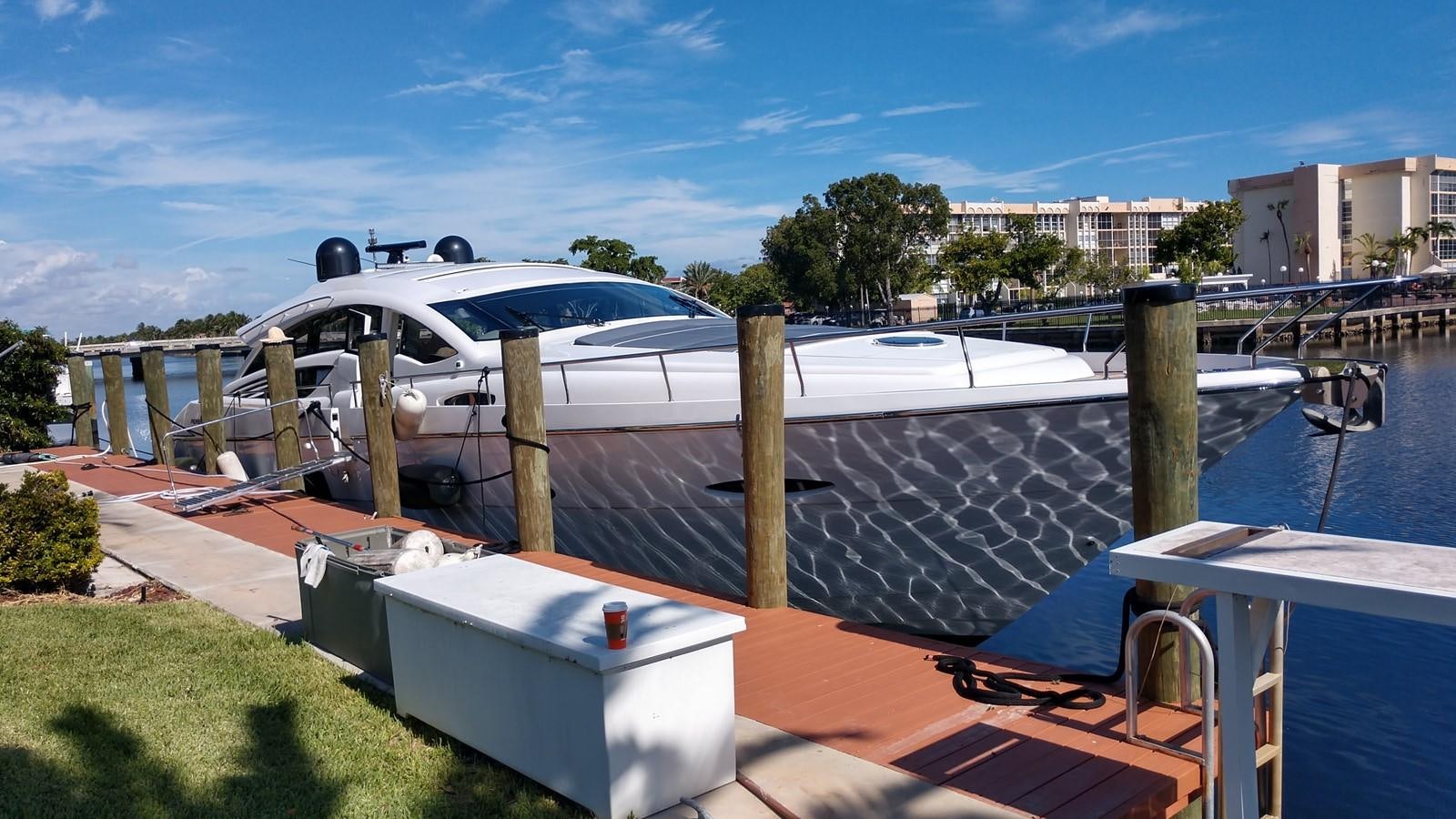 a building with a roof and a pool with a pool in the foreground aboard VANTAGE Yacht for Sale