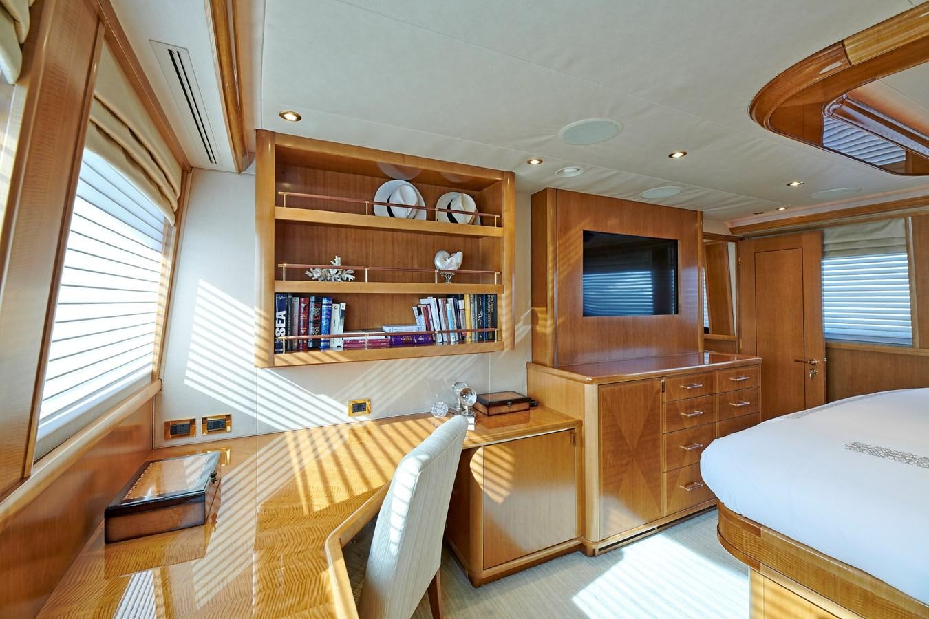 a room with a bed and a bookcase aboard HATATY Yacht for Sale