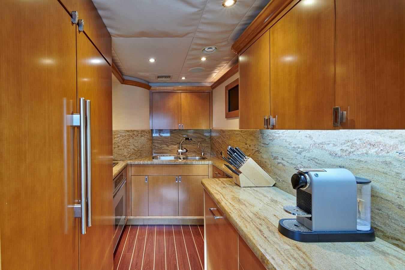 a kitchen with wooden cabinets aboard HATATY Yacht for Sale