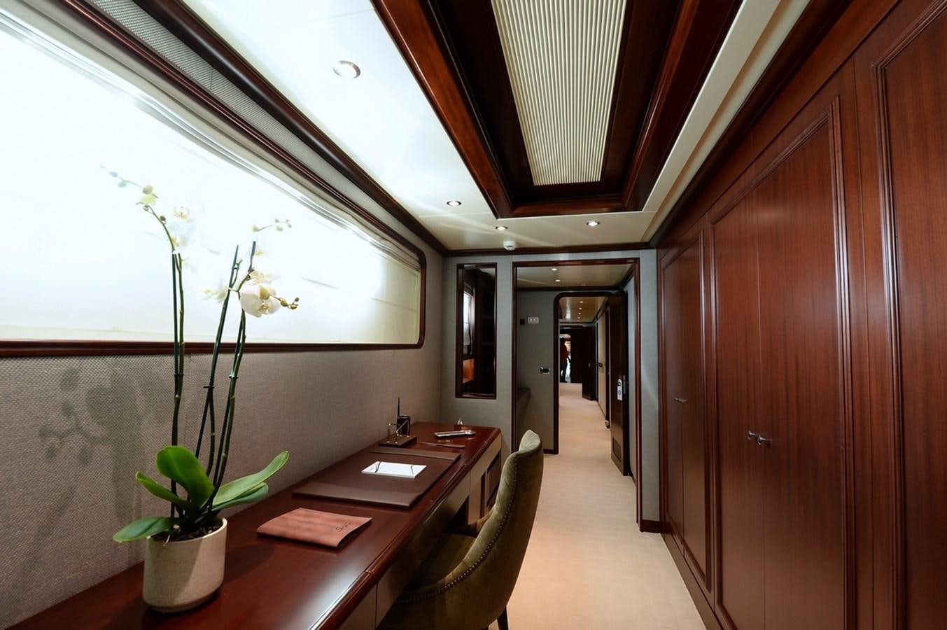 a room with a table and a plant in it aboard SHAF Yacht for Sale