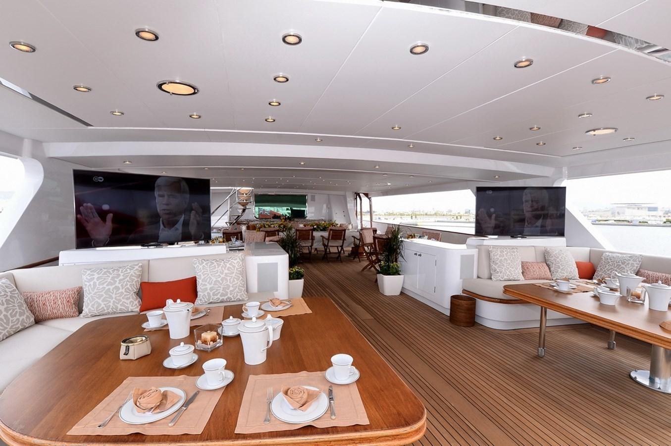 a living room with a large screen aboard SHAF Yacht for Sale