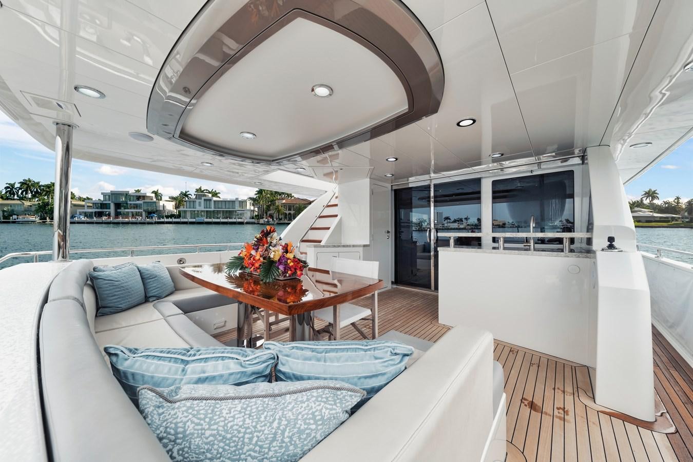 a living room with a large balcony aboard 2019 OCEAN ALEXANDER 88 SKYLOUNGE MUDSLINGER Yacht for Sale