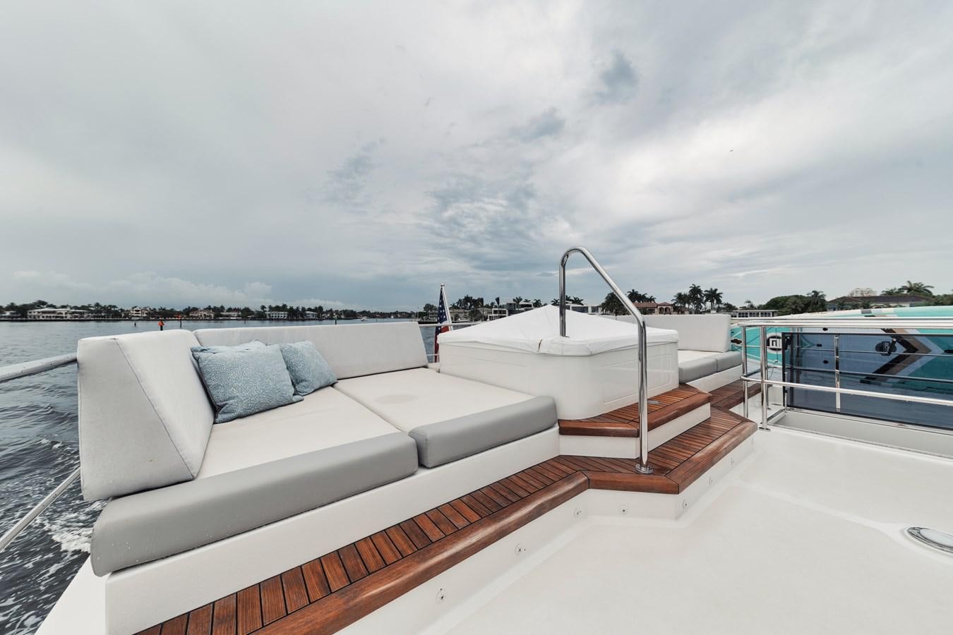 a white couch on a boat aboard 2019 OCEAN ALEXANDER 88 SKYLOUNGE MUDSLINGER Yacht for Sale
