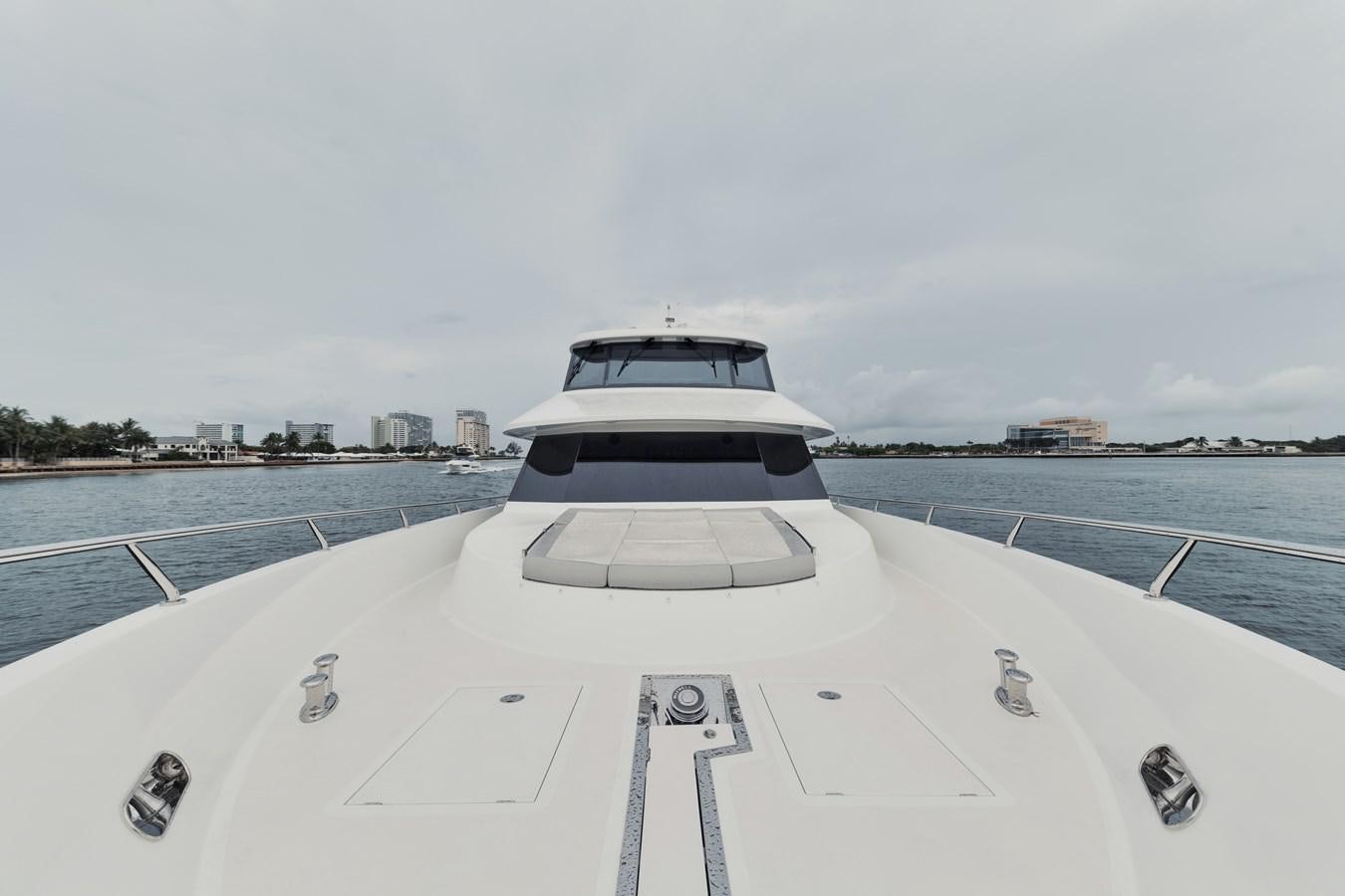 a white car on a snowy road aboard 2019 OCEAN ALEXANDER 88 SKYLOUNGE MUDSLINGER Yacht for Sale