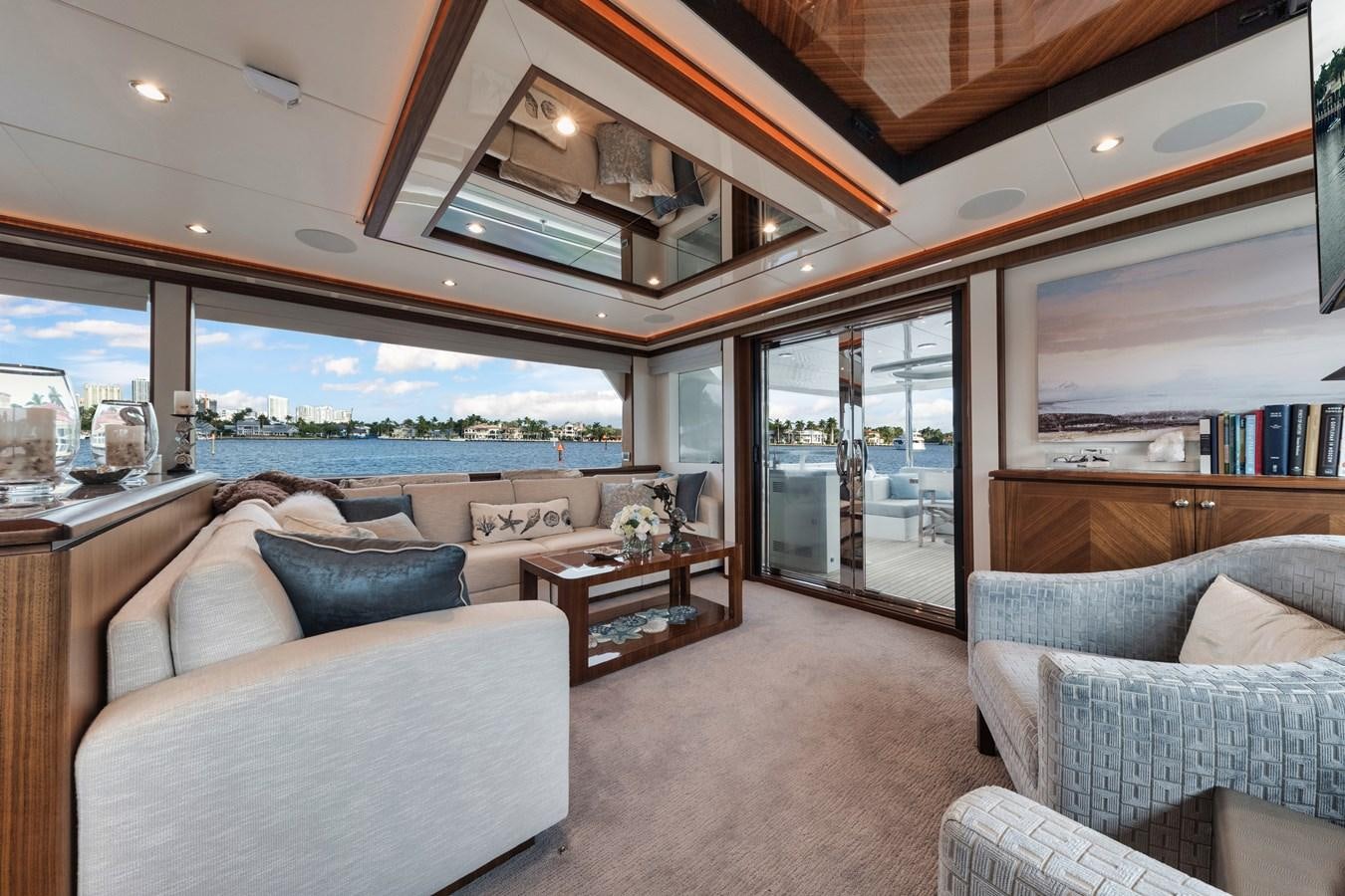 a living room with a large window aboard 2019 OCEAN ALEXANDER 88 SKYLOUNGE MUDSLINGER Yacht for Sale