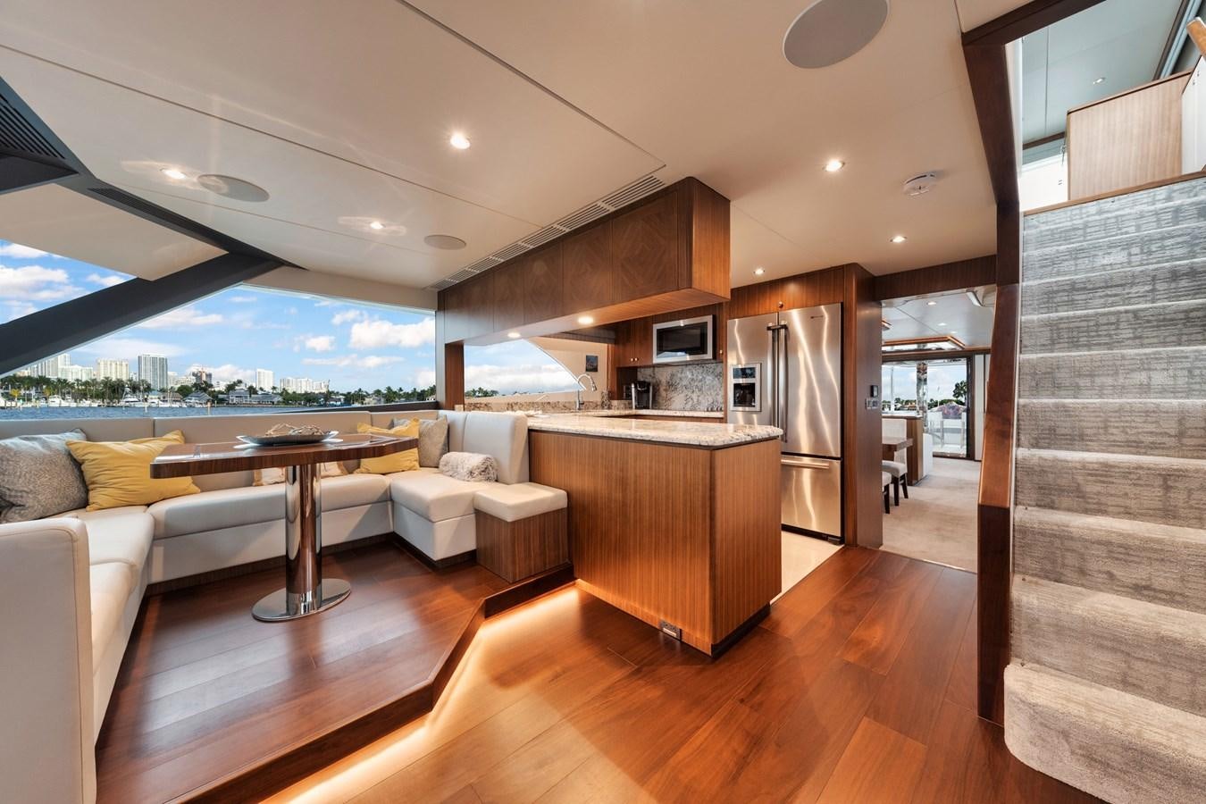 a modern looking living room aboard 2019 OCEAN ALEXANDER 88 SKYLOUNGE MUDSLINGER Yacht for Sale