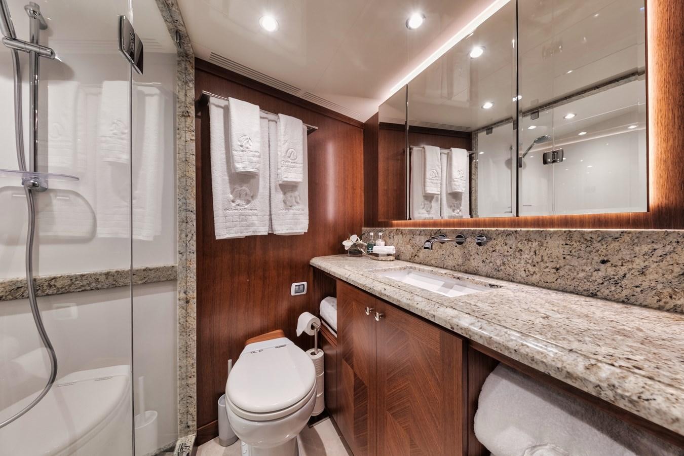 a bathroom with a marble counter top aboard 2019 OCEAN ALEXANDER 88 SKYLOUNGE MUDSLINGER Yacht for Sale