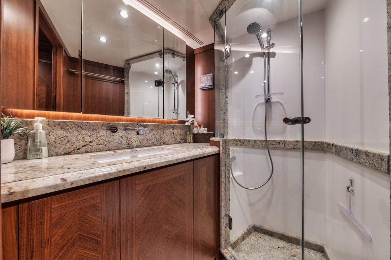 a bathroom with a large mirror aboard 2019 OCEAN ALEXANDER 88 SKYLOUNGE MUDSLINGER Yacht for Sale