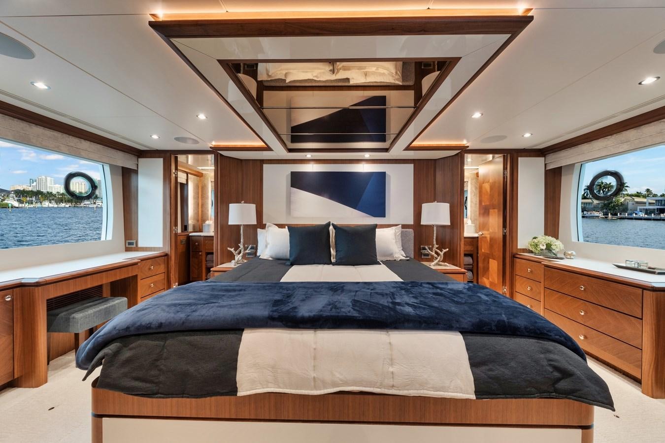 a large bed in a room aboard 2019 OCEAN ALEXANDER 88 SKYLOUNGE MUDSLINGER Yacht for Sale