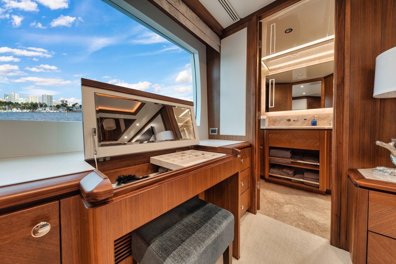 a room with a large window and a view of the water aboard 2019 OCEAN ALEXANDER 88 SKYLOUNGE MUDSLINGER Yacht for Sale