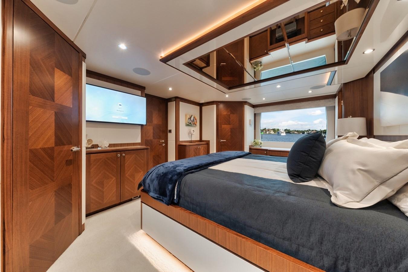a bedroom with a large bed aboard 2019 OCEAN ALEXANDER 88 SKYLOUNGE MUDSLINGER Yacht for Sale
