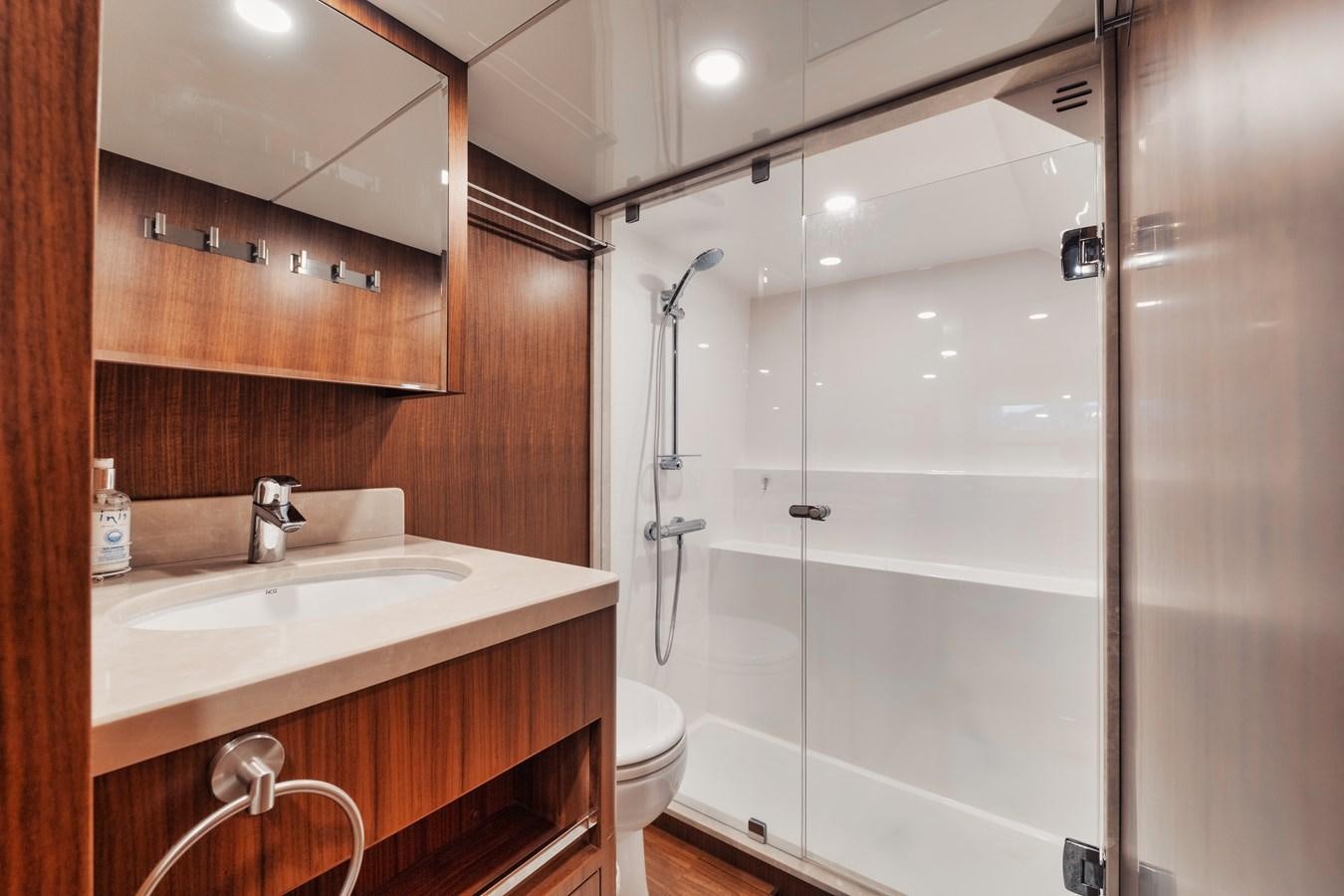 a bathroom with a shower unit and sink aboard 2019 OCEAN ALEXANDER 88 SKYLOUNGE MUDSLINGER Yacht for Sale