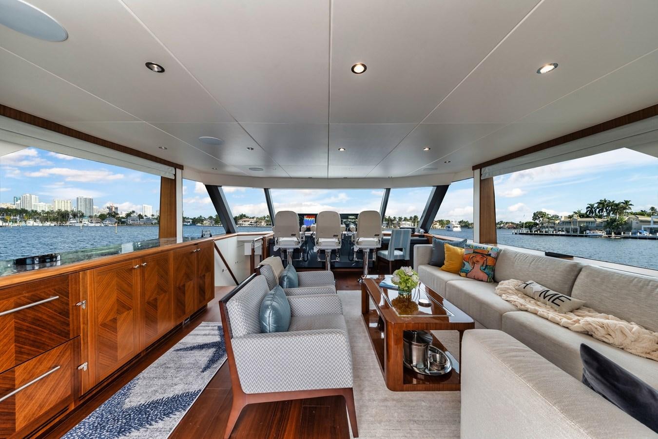 a living room with a large window aboard 2019 OCEAN ALEXANDER 88 SKYLOUNGE MUDSLINGER Yacht for Sale