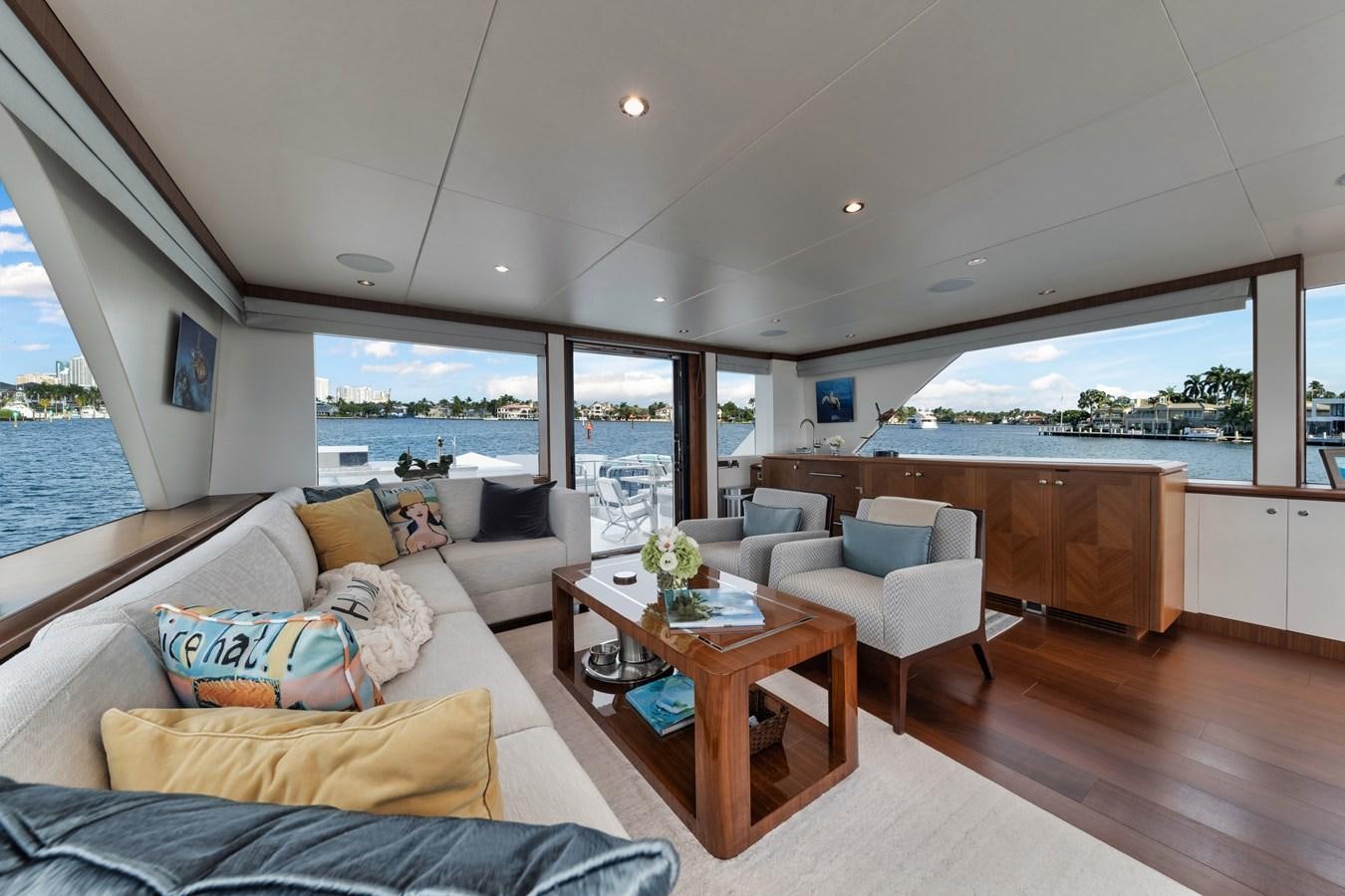 a living room with a large window aboard 2019 OCEAN ALEXANDER 88 SKYLOUNGE MUDSLINGER Yacht for Sale