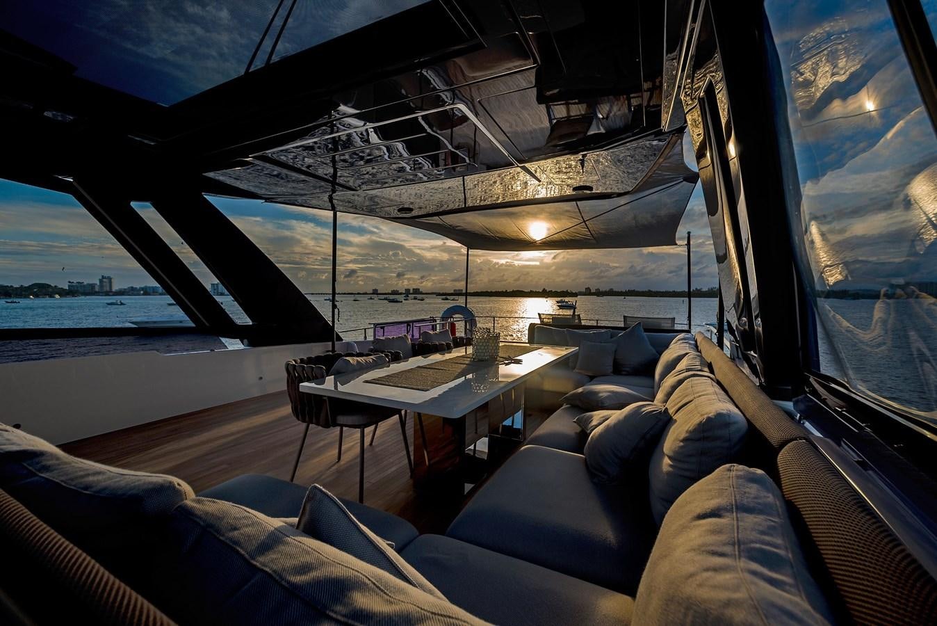 a room with a couch and a table and a window with a view of the ocean aboard LA MARTINA Yacht for Sale