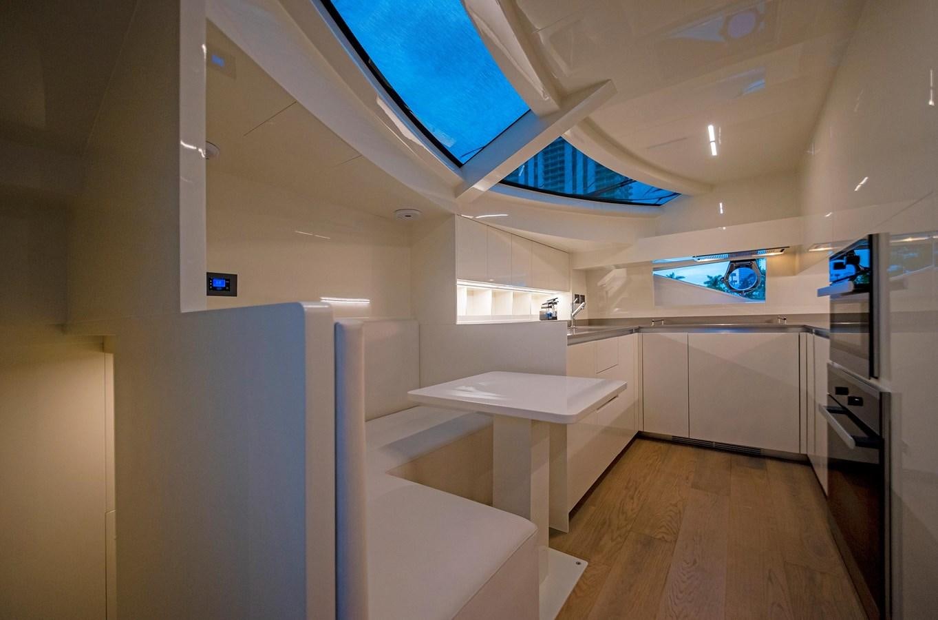 a room with a table and a tv on the ceiling aboard LA MARTINA Yacht for Sale