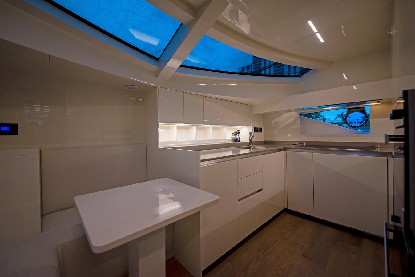 a kitchen with a table and cabinets aboard LA MARTINA Yacht for Sale