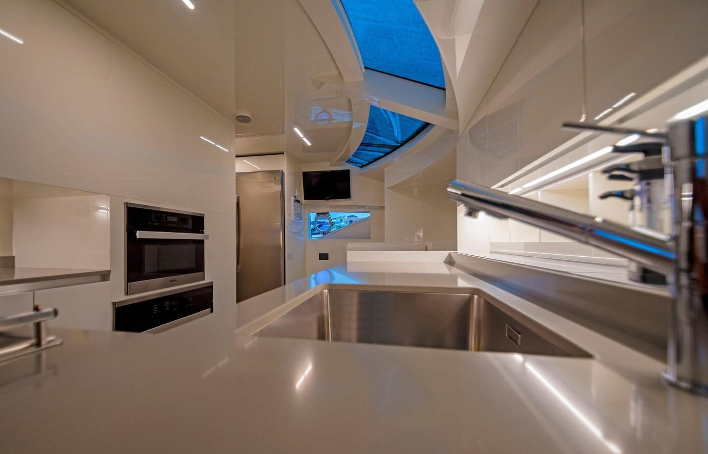 a kitchen with a large stainless steel oven and a large white counter aboard LA MARTINA Yacht for Sale