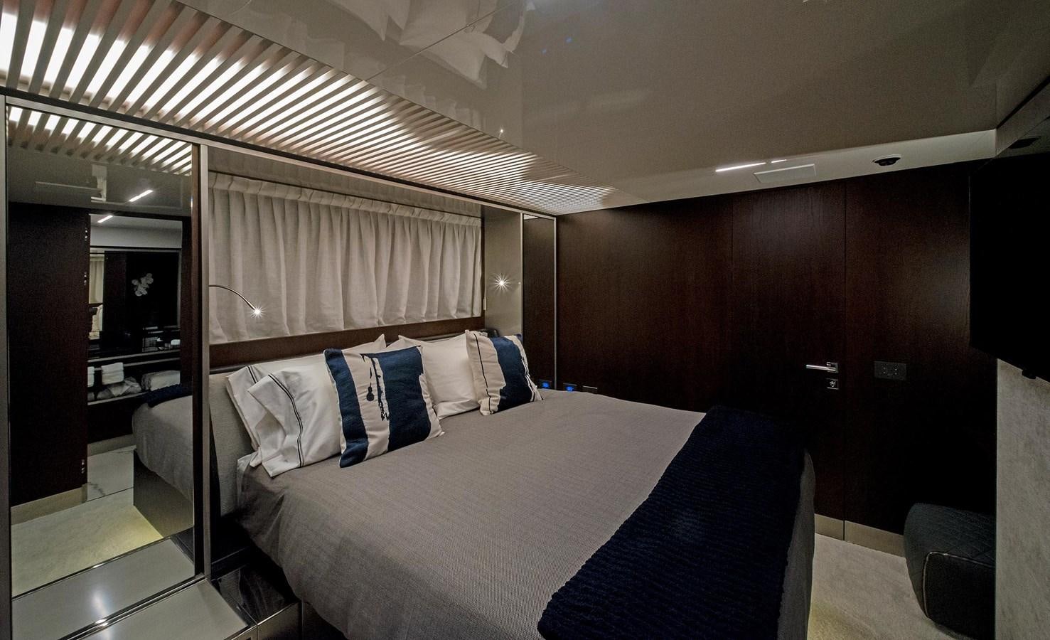 a room with a bed and a mirror aboard LA MARTINA Yacht for Sale
