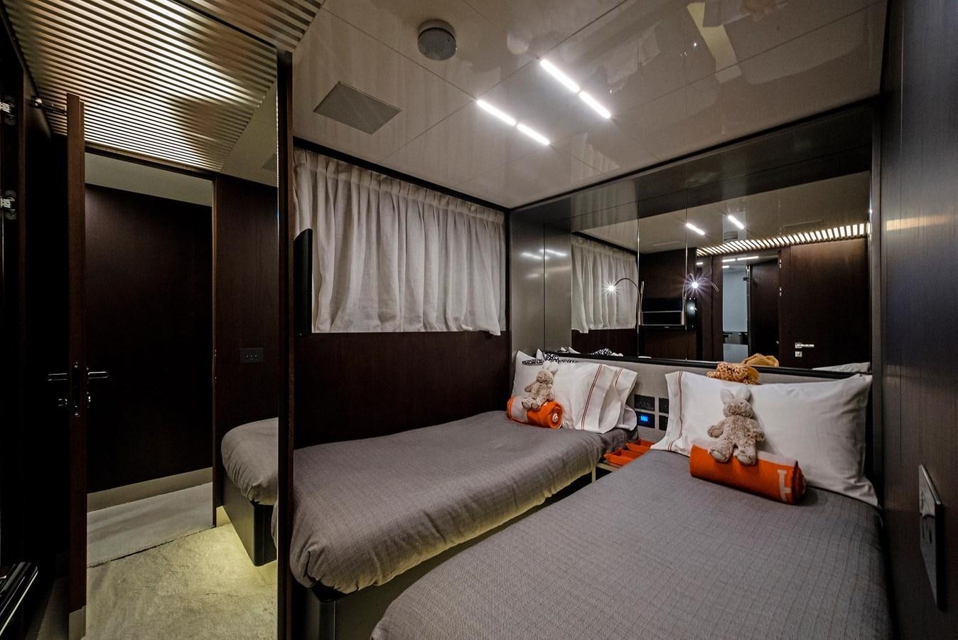 a bedroom with a large mirror aboard LA MARTINA Yacht for Sale