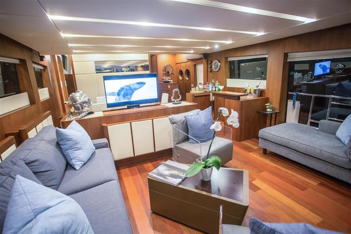a living room with a tv and furniture aboard BLUOCEAN Yacht for Sale