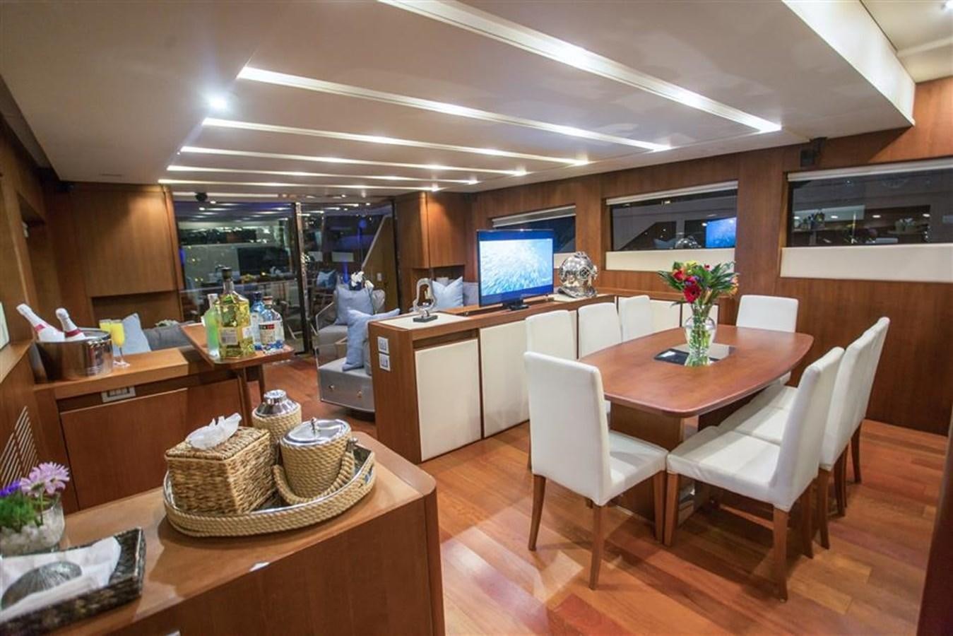 a modern looking kitchen with a large table and chairs aboard BLUOCEAN Yacht for Sale