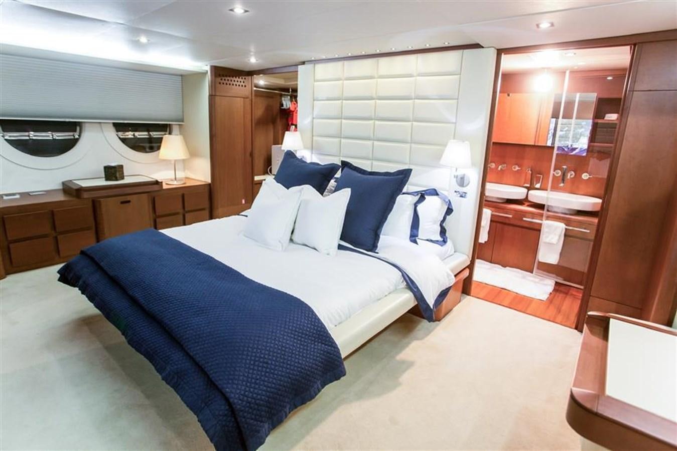 a bedroom with a bed and a desk aboard BLUOCEAN Yacht for Sale