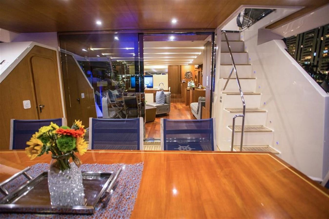 a large room with a table and chairs aboard BLUOCEAN Yacht for Sale