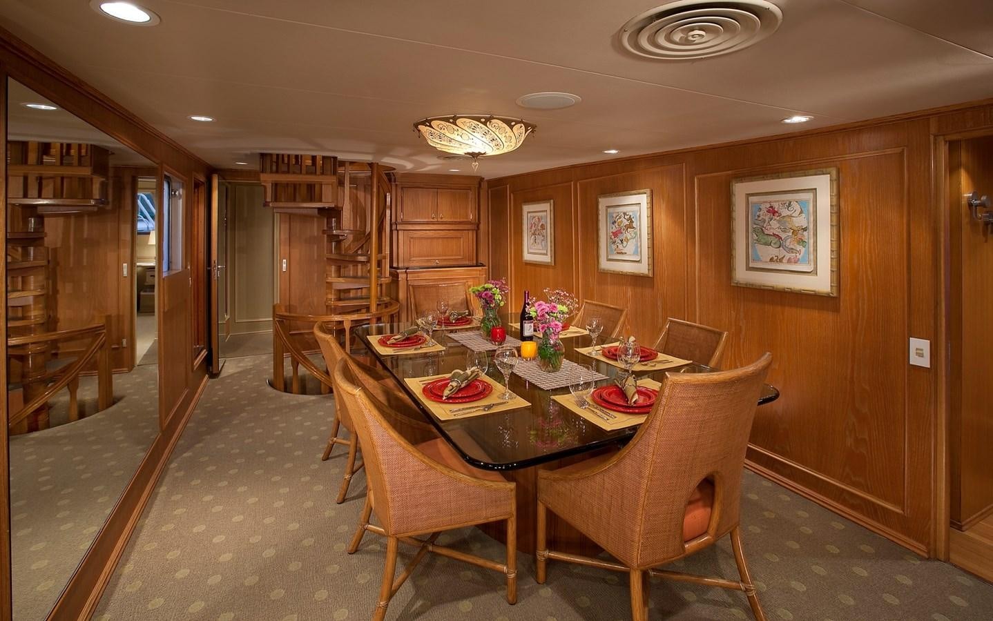 a dining room with a table and chairs aboard MONTEGO Yacht for Sale