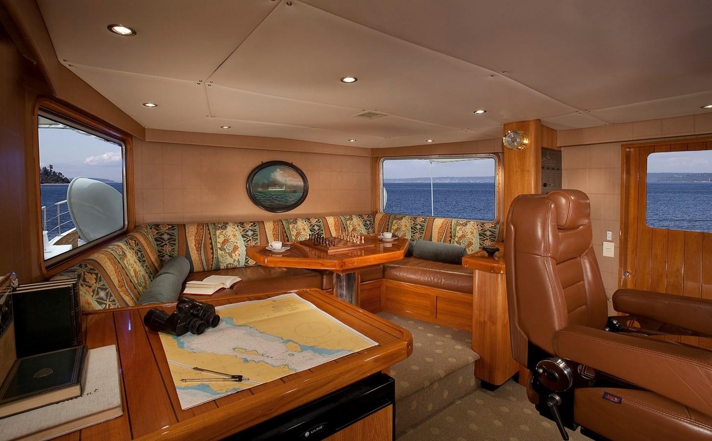 a living room with a couch and a television aboard MONTEGO Yacht for Sale